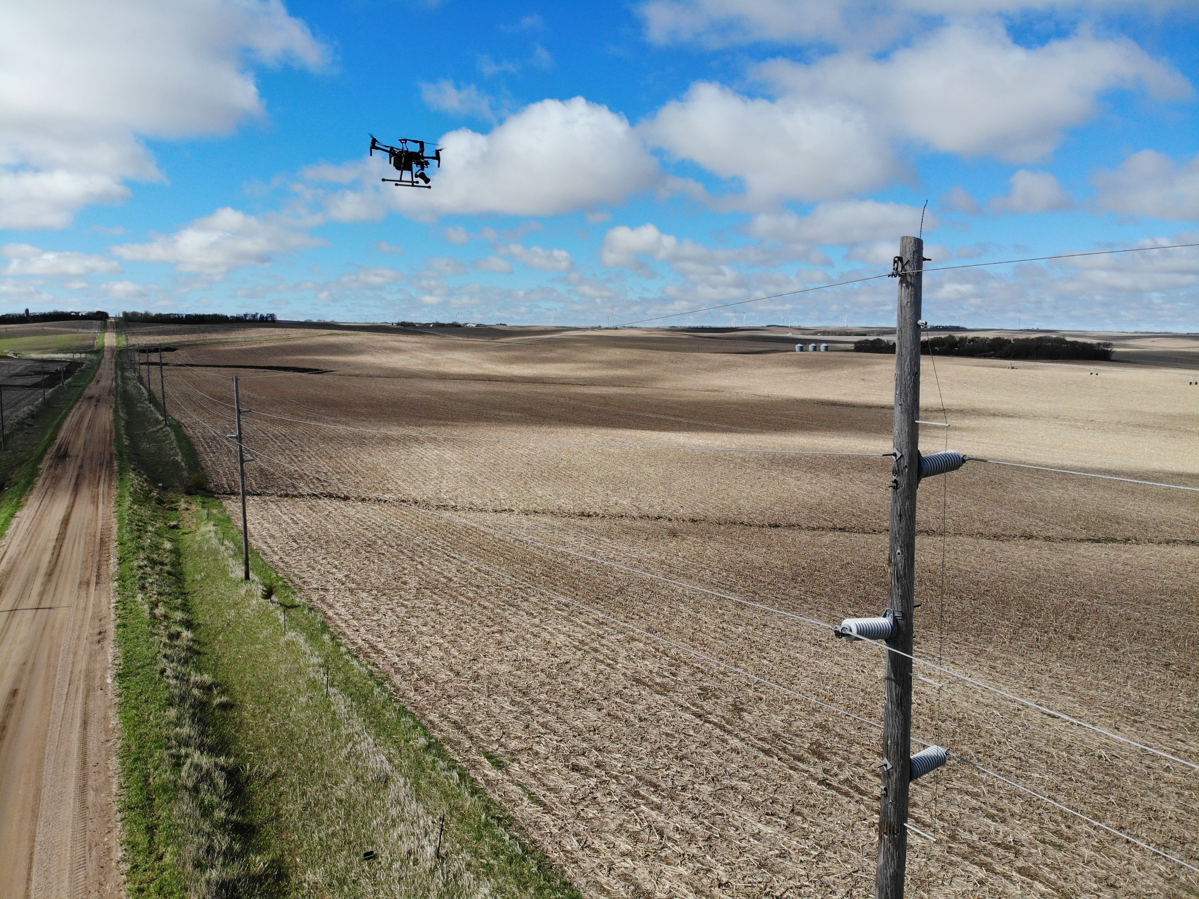 Drone inspecting electric power transmission line